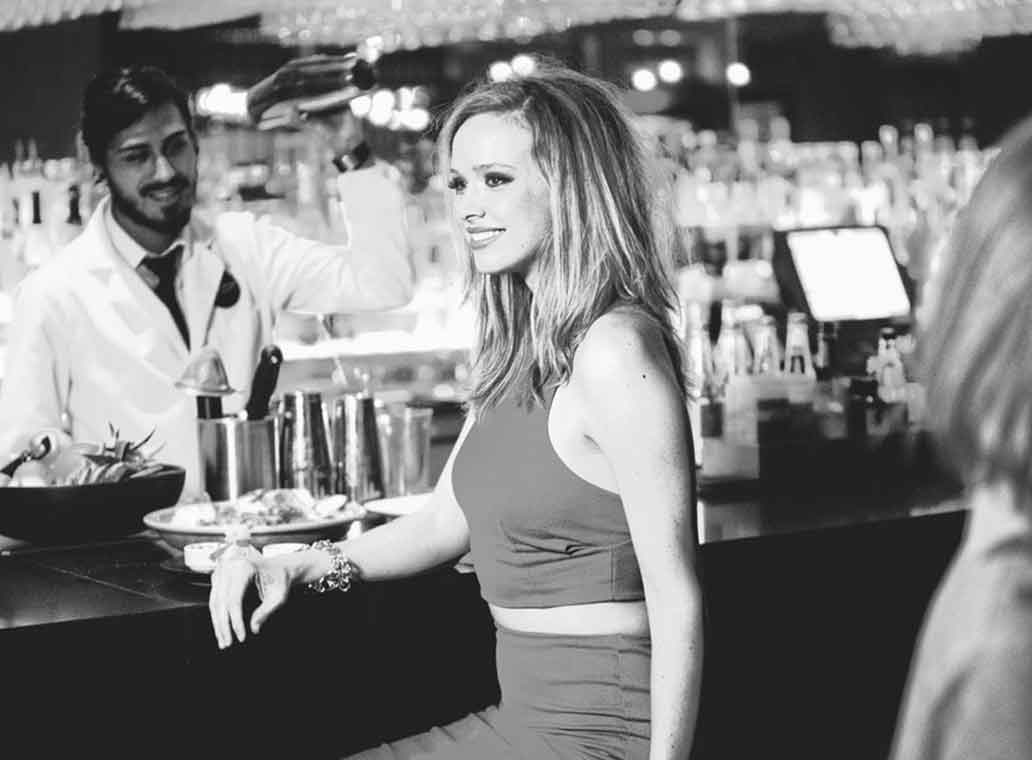 Woman sitting at restaurant bar