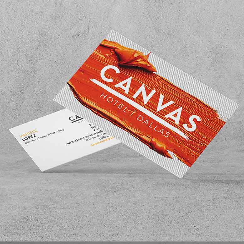 Two business cards for Canvas Hotel Dallas, one showing the logo over orange paint, the other with contact details.