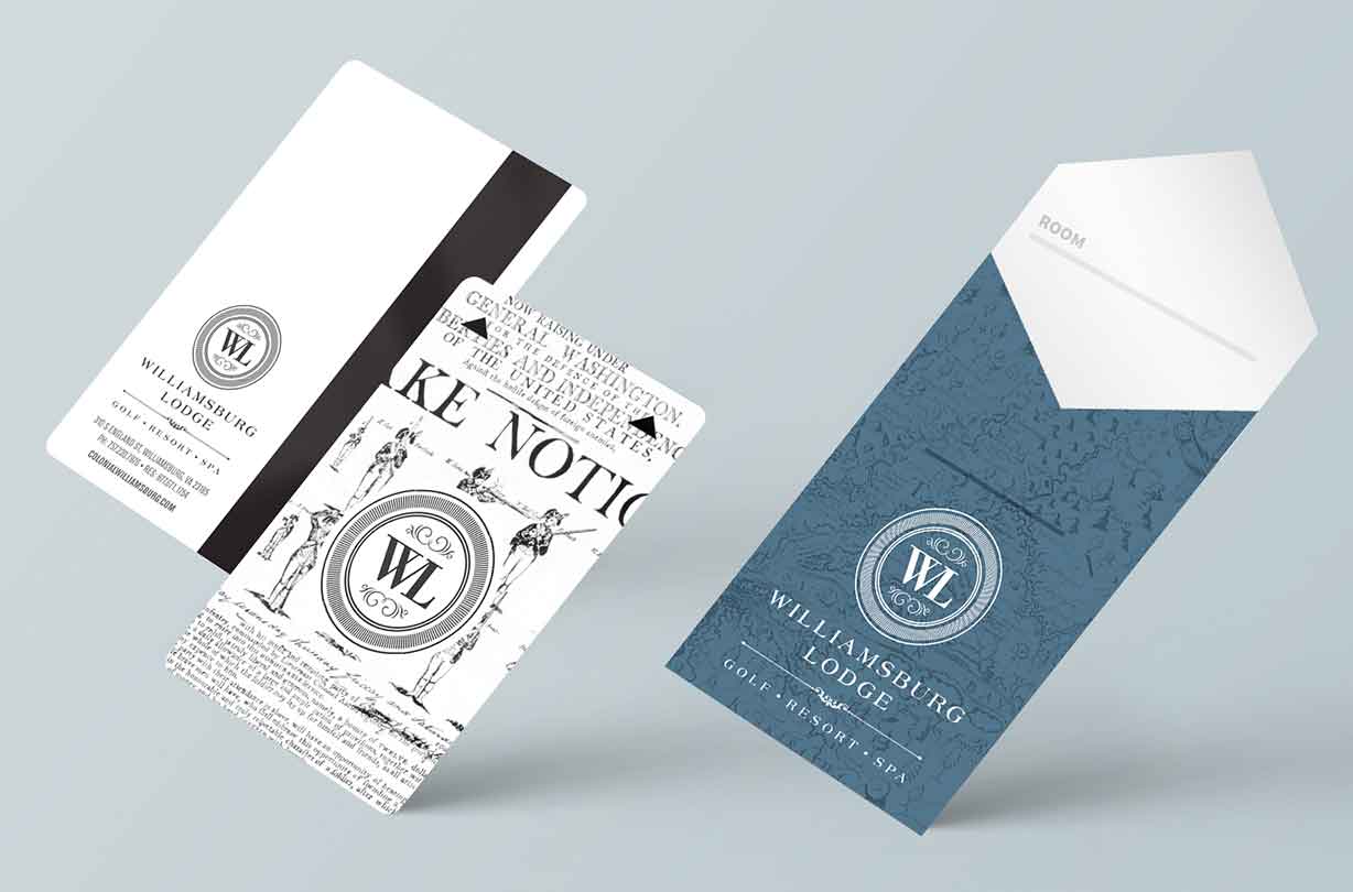 Three Williamsburg Lodge hotel keycards and a blue keycard holder with white logo on a light gray background.