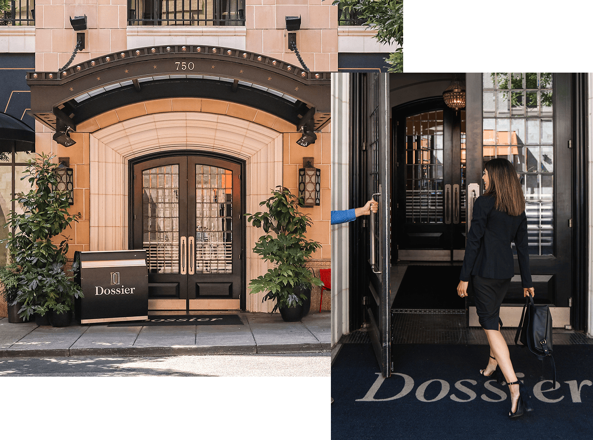 Entrance to Hotel Dossier with arched double doors; a woman in business attire enters.