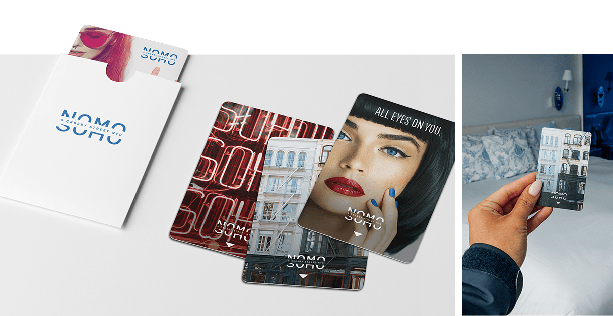 Three stylish key cards labeled NOMO SOHO with a white card holder and a hotel room key card in use.