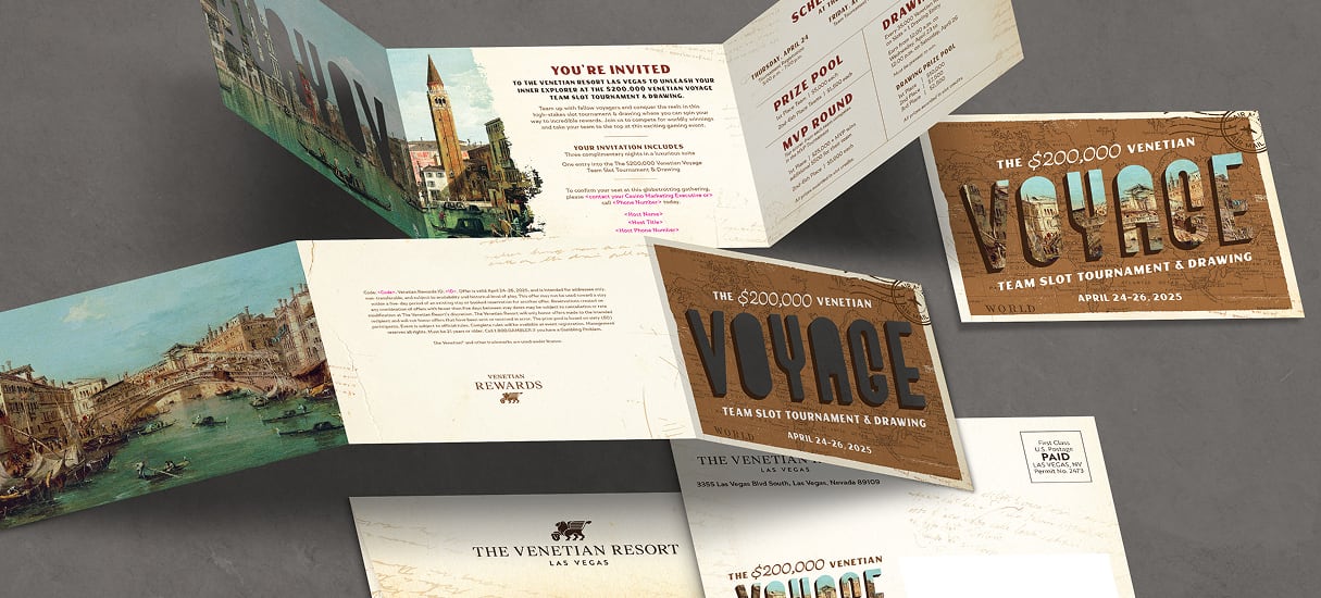Brochures and postcards for The Venetian Resort’s €200,000 Voyage slot tournament on a gray surface.